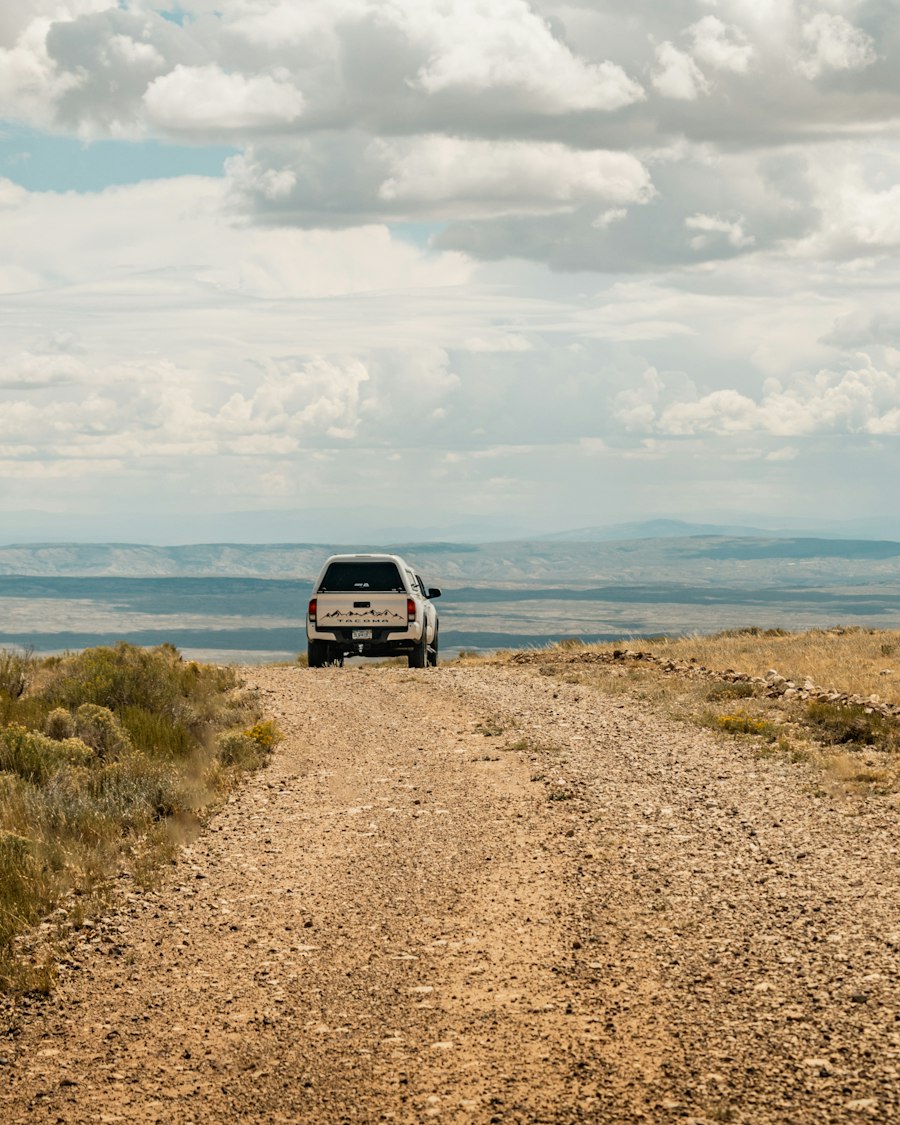 A pickup at the end of a gravel road through dry rangeland